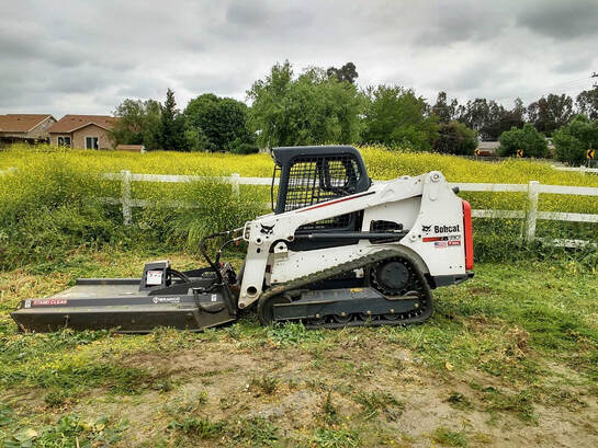 Landcape contractor preparing and grading the land for agriculture 